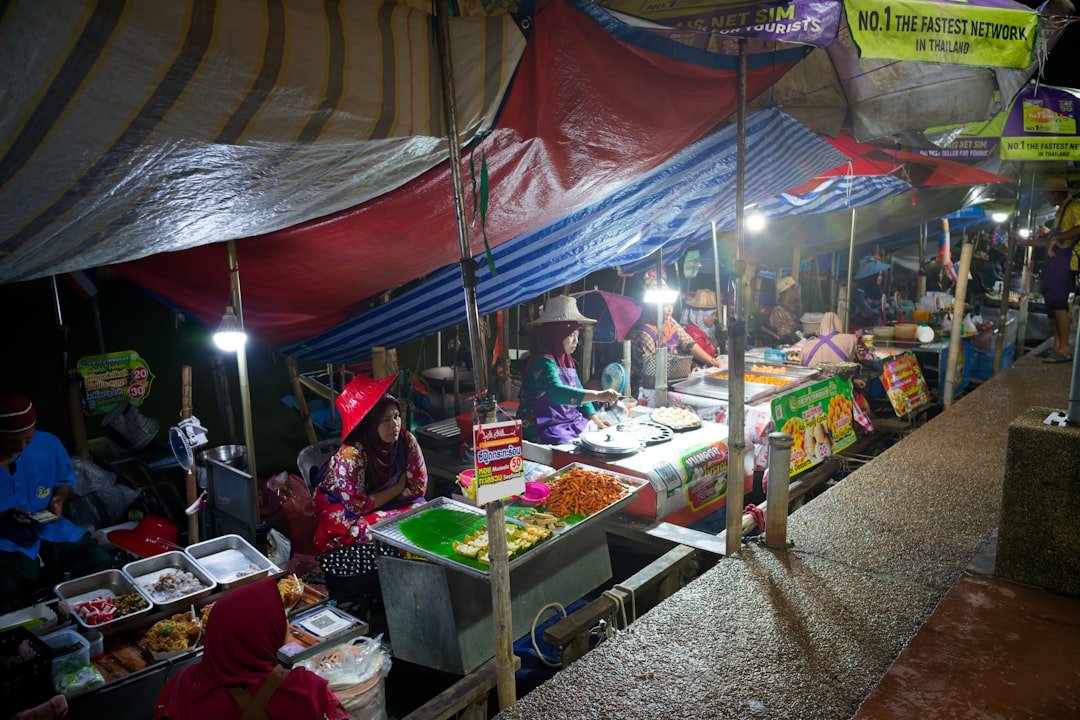 Vibrant street food market with vendor cooking fresh local dishes at night market stall