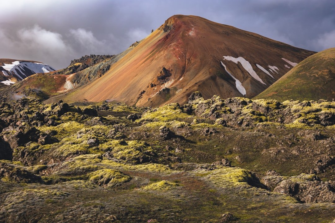 Colorful rhyolite mountains of Landmannalaugar with hikers on trail in Iceland